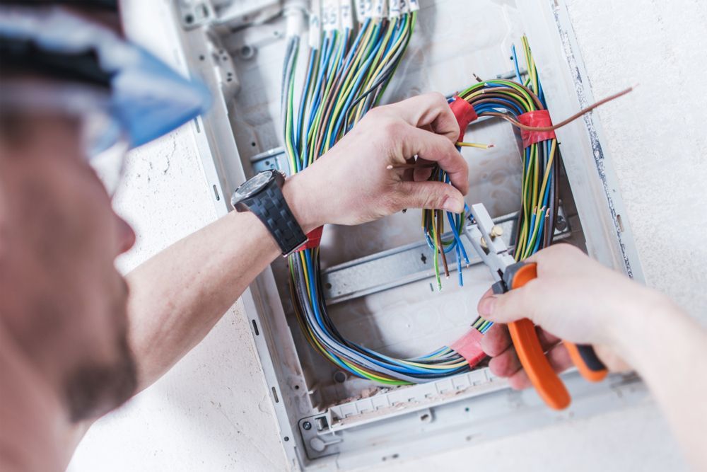 Cairns Excel Electrics electrician working on an electrical box with a pair of pliers in Bungalow, Cairns